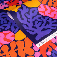 Colorful coral patterned paper with a ruler on a dark blue background